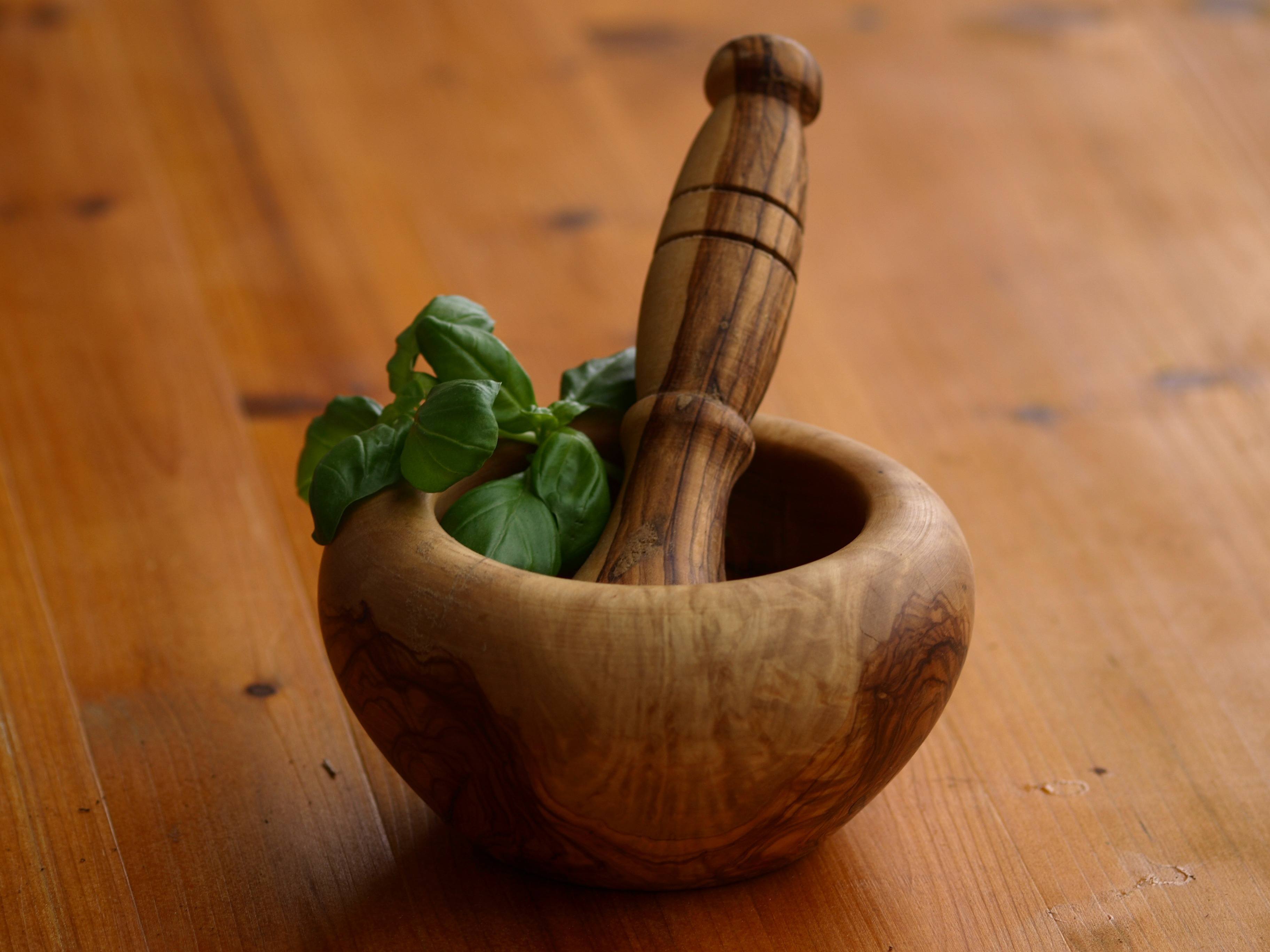 mortar and pestle with basil leaves